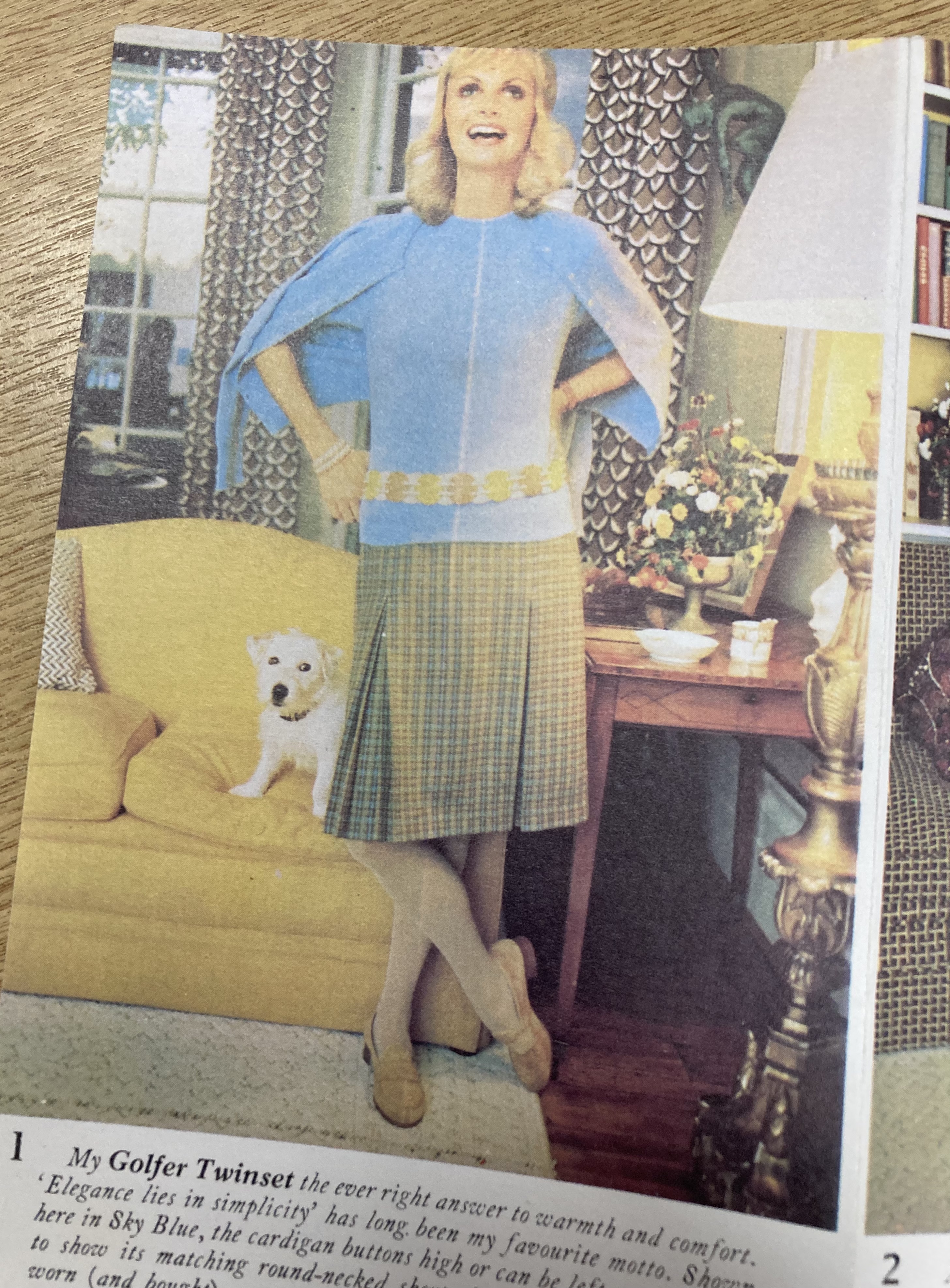 Photograph from inside a brochure showing a women in knitted jumper and skirt